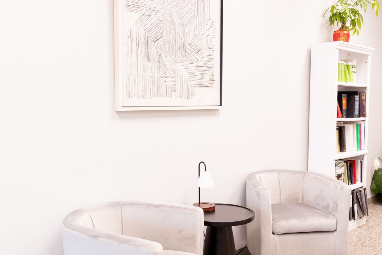 Two armchairs and a side table in the Meliora Law seating area