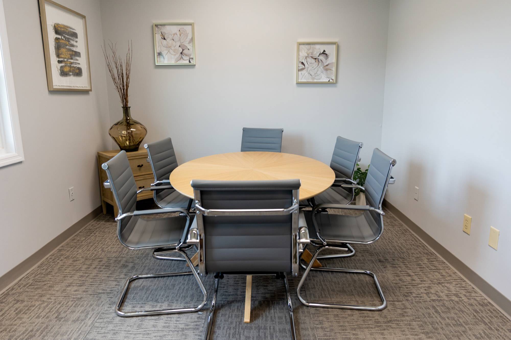 A small Meliora Law conference room, chairs set around the table